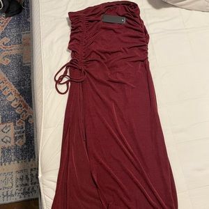 Burgundy form fitting skirt with a slit